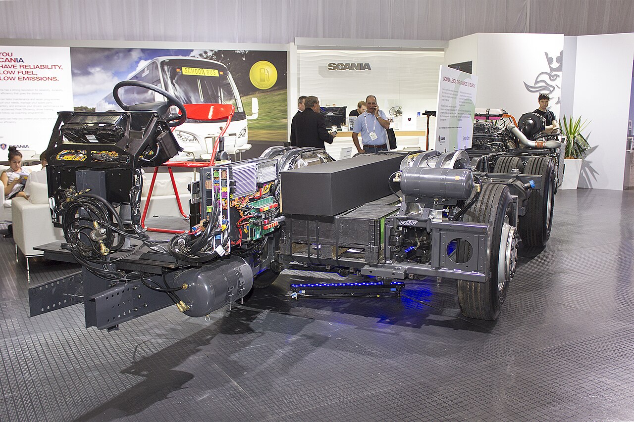 A bare Scania K-series bus chassis with engine, axles and frame but no body