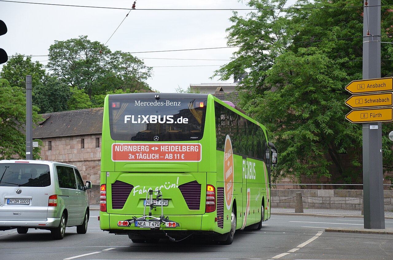 A green FlixBus Mercedes-Benz Tourismo coach.