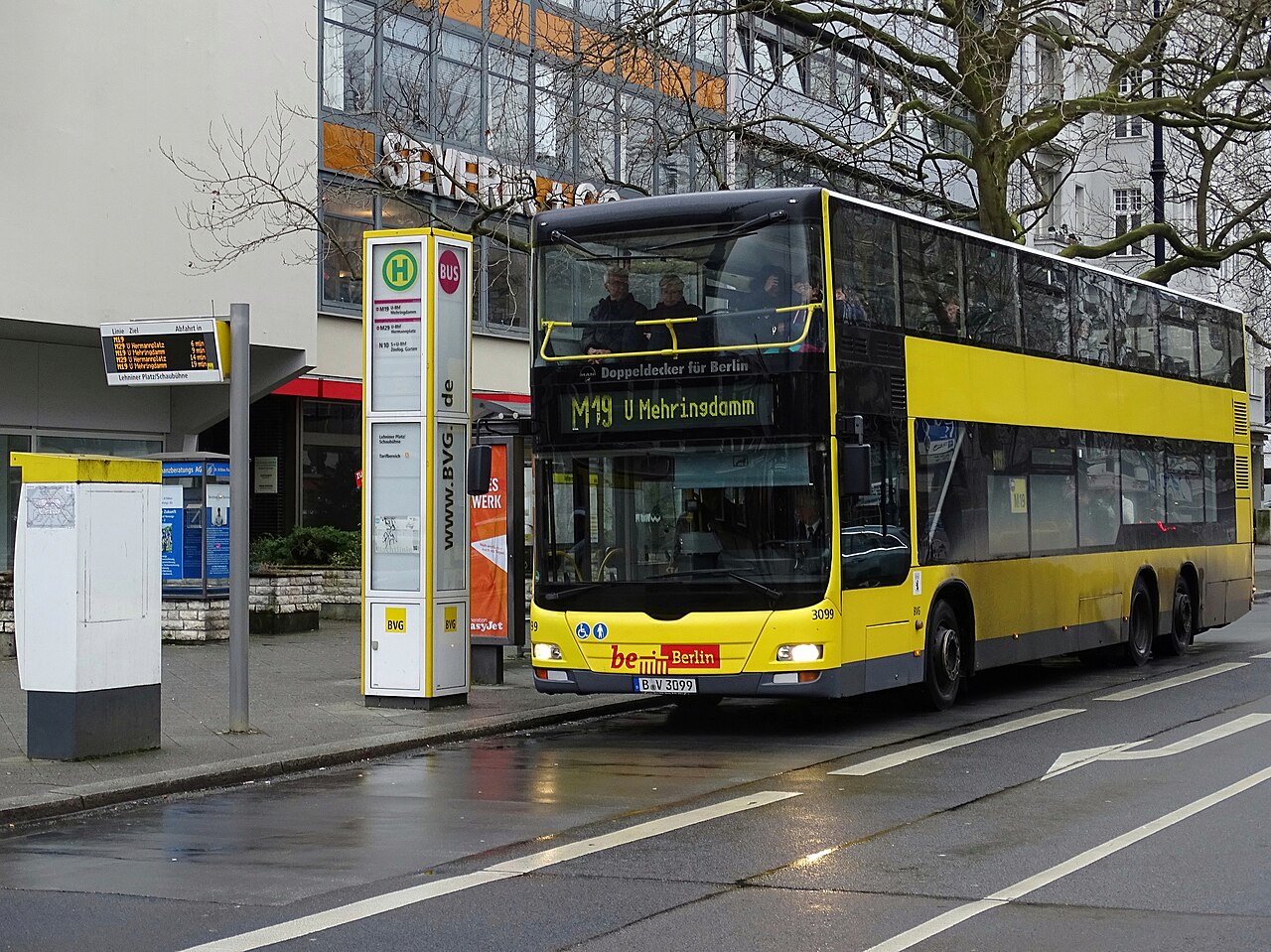 A yellow BVG MAN Lion's City DD double-decker bus on the Kurfürstendamm in Berlin