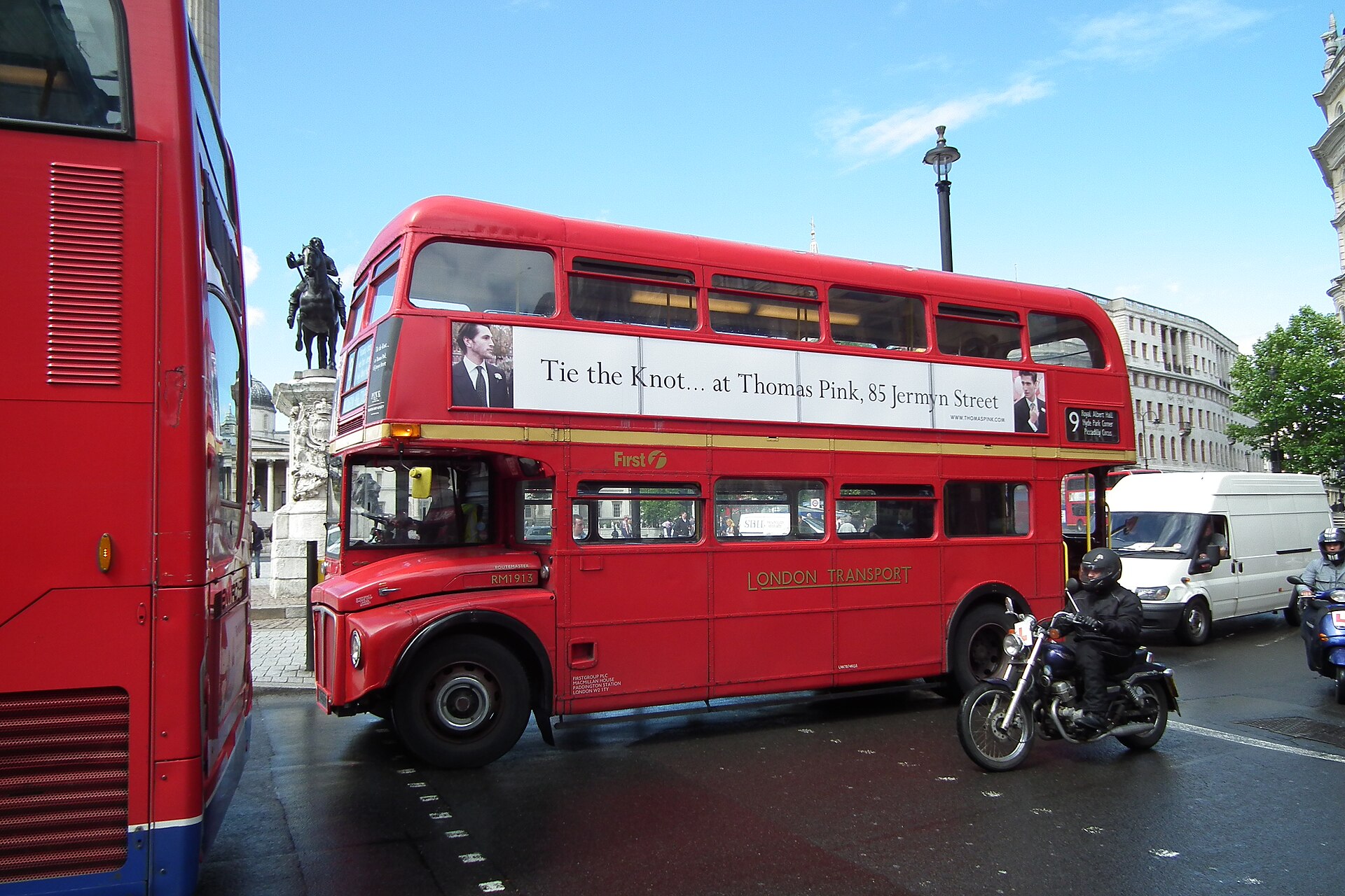 A classic red 1964 AEC Routemaster double-decker bus in Trafalgar Square, London, on heritage route 9.