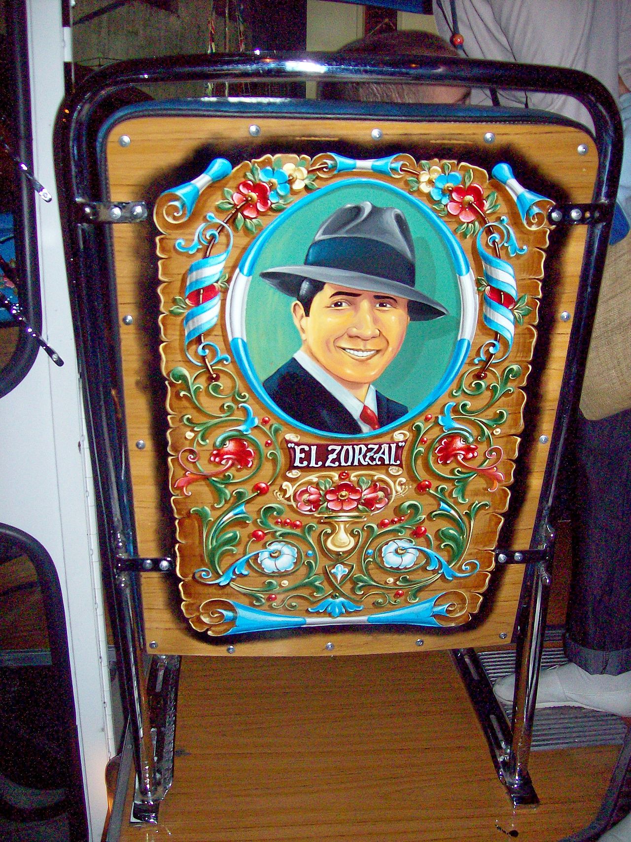 Fileteado painting of tango singer Carlos Gardel inside an old Buenos Aires colectivo, behind the driver's seat.
