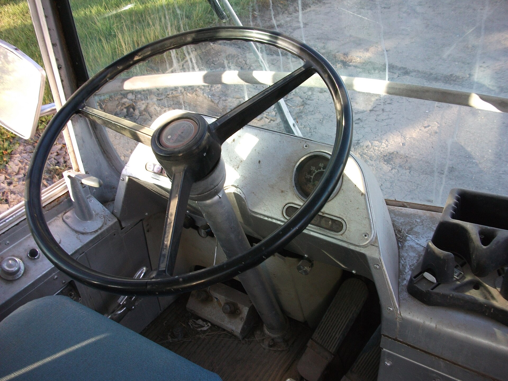 The driver's dashboard and curved windshield inside a 1966 GM New Look Fishbowl bus.