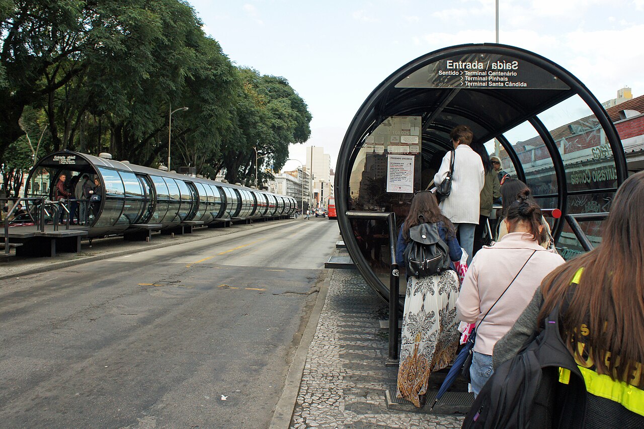Passengers queuing to enter a Curitiba tube station, where fares are paid before boarding