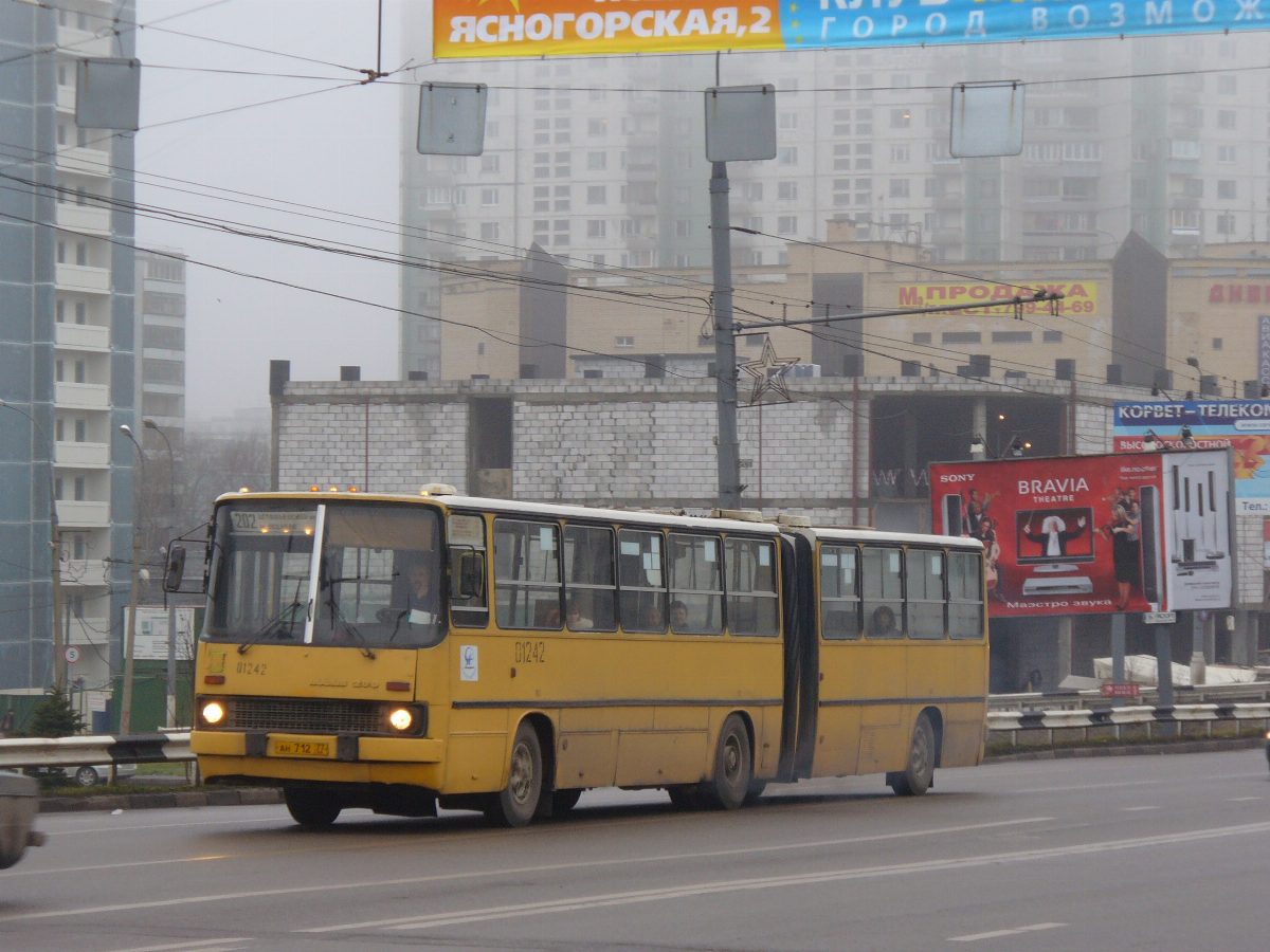 A classic orange Ikarus 280 articulated bus on a Moscow street, the icon of Soviet-era transport