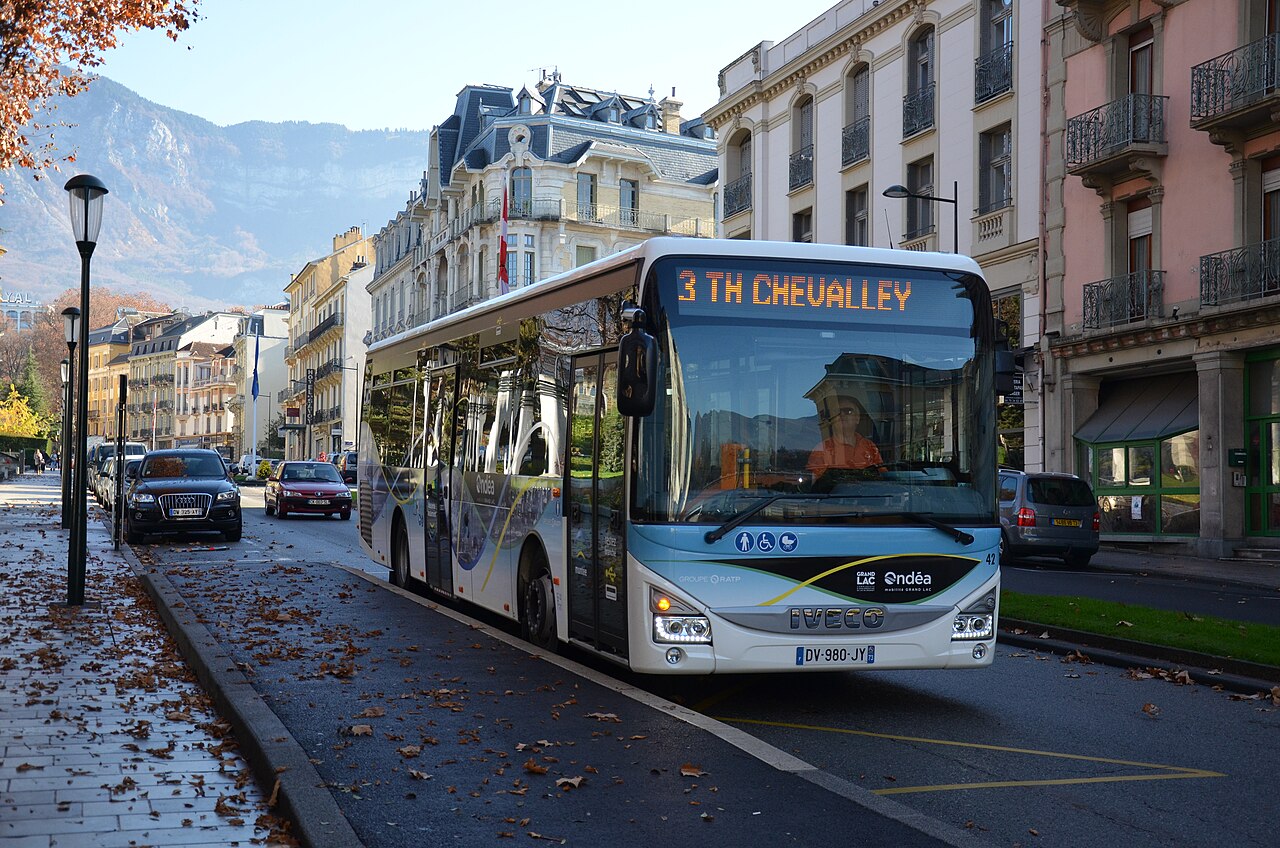 An Iveco Bus Crossway LE low-entry bus at a railway station, with a step-free front door.