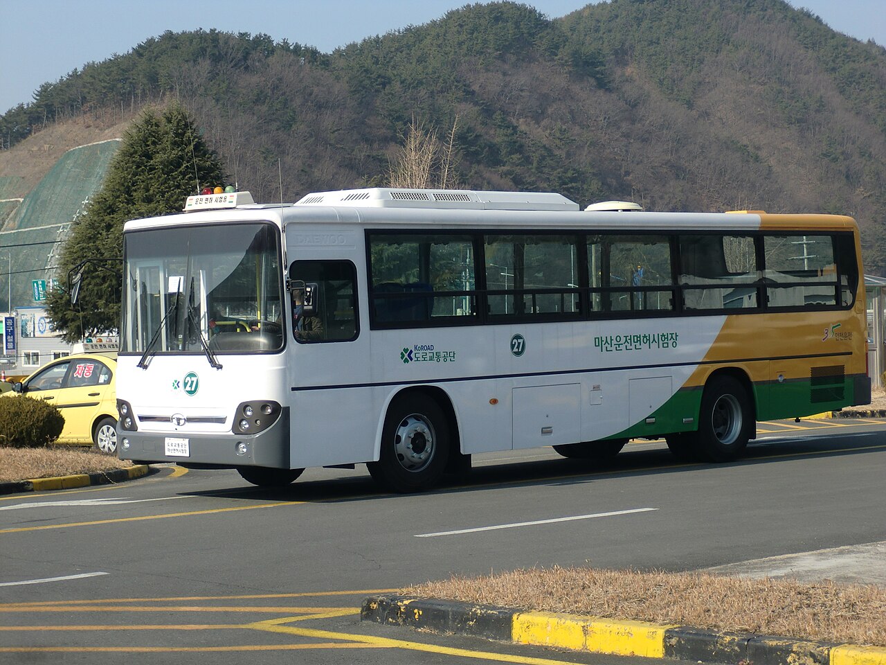 A Daewoo BS106 Royal City standard-length city bus driving in Masan, South Korea