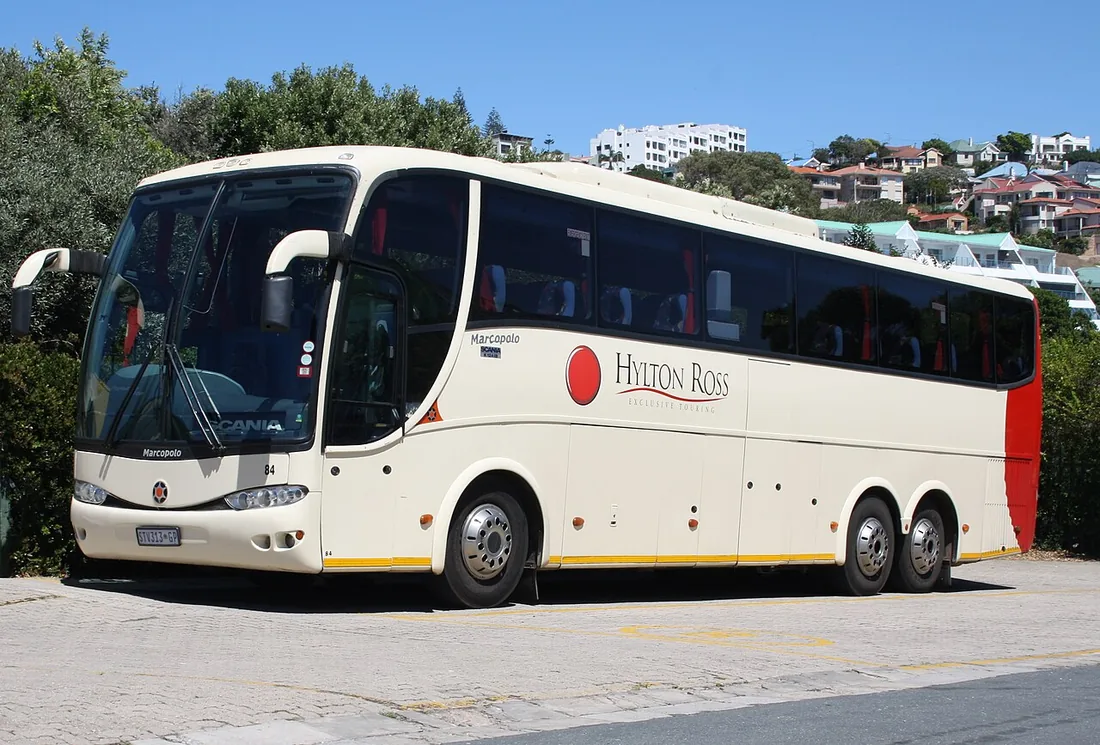 A Scania K-series coach with a Marcopolo body in Hylton Ross livery, showing the high-floor touring layout.