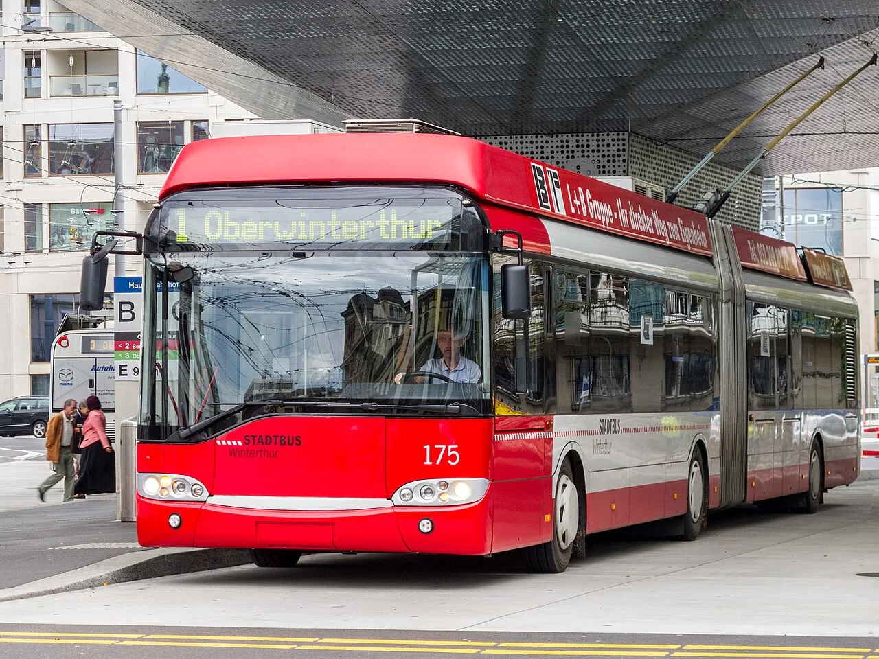 A Solaris Trollino 18 articulated trolleybus with overhead poles in Winterthur, Switzerland.