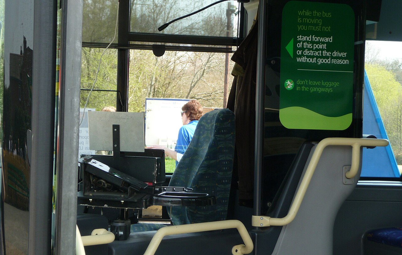 The driver's cab of a real bus, showing the dashboard, steering wheel and controls