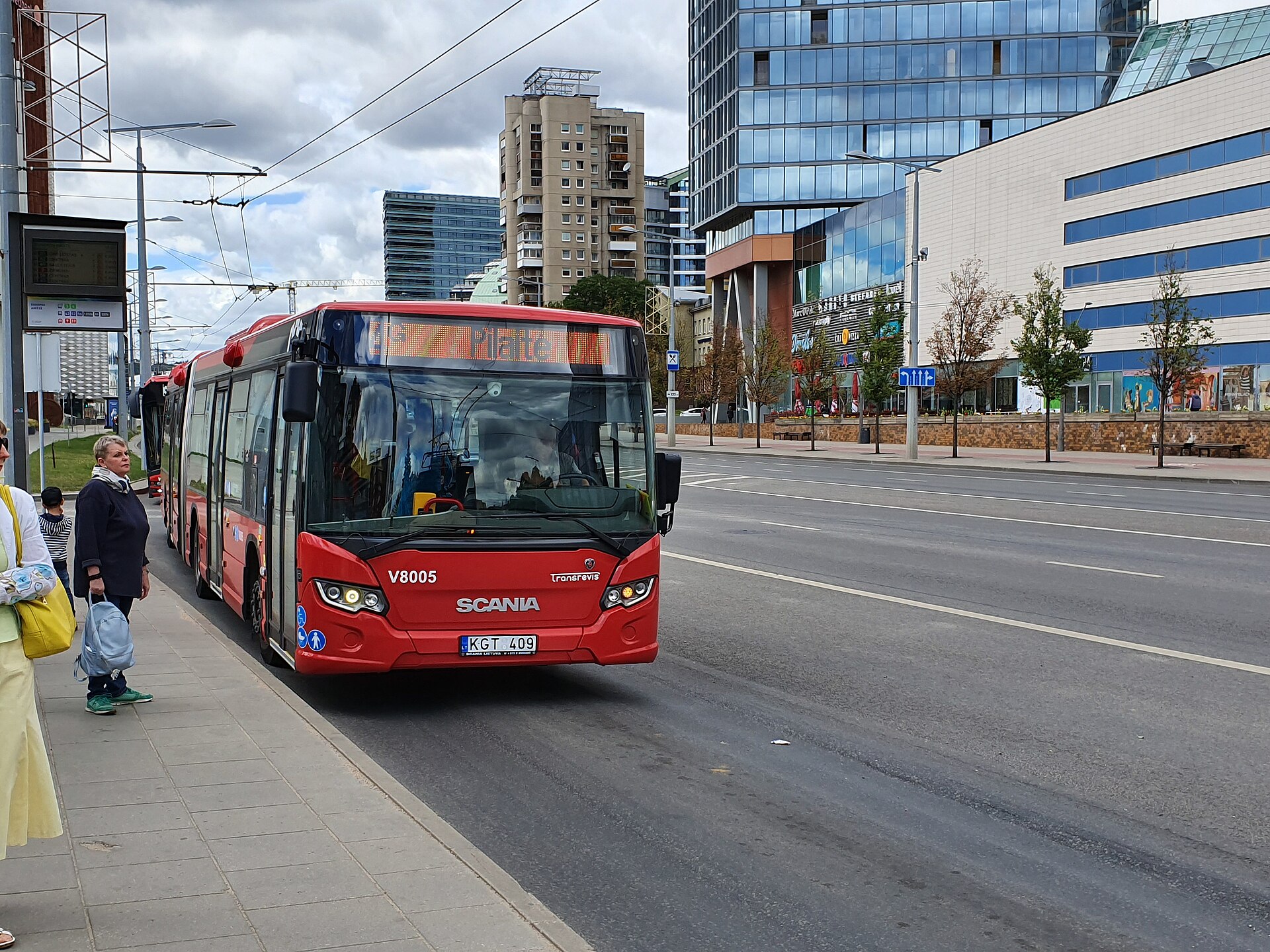 A Scania Citywide LF low-floor city bus in Vilnius, Lithuania, in city transit livery at a stop.