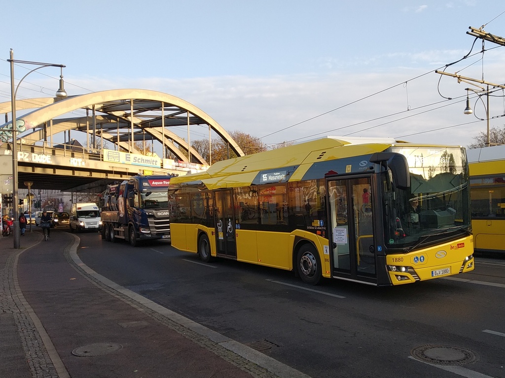 A white-and-grey Solaris Urbino 12 electric city bus at a Berlin stop, single standard-length low-floor body.