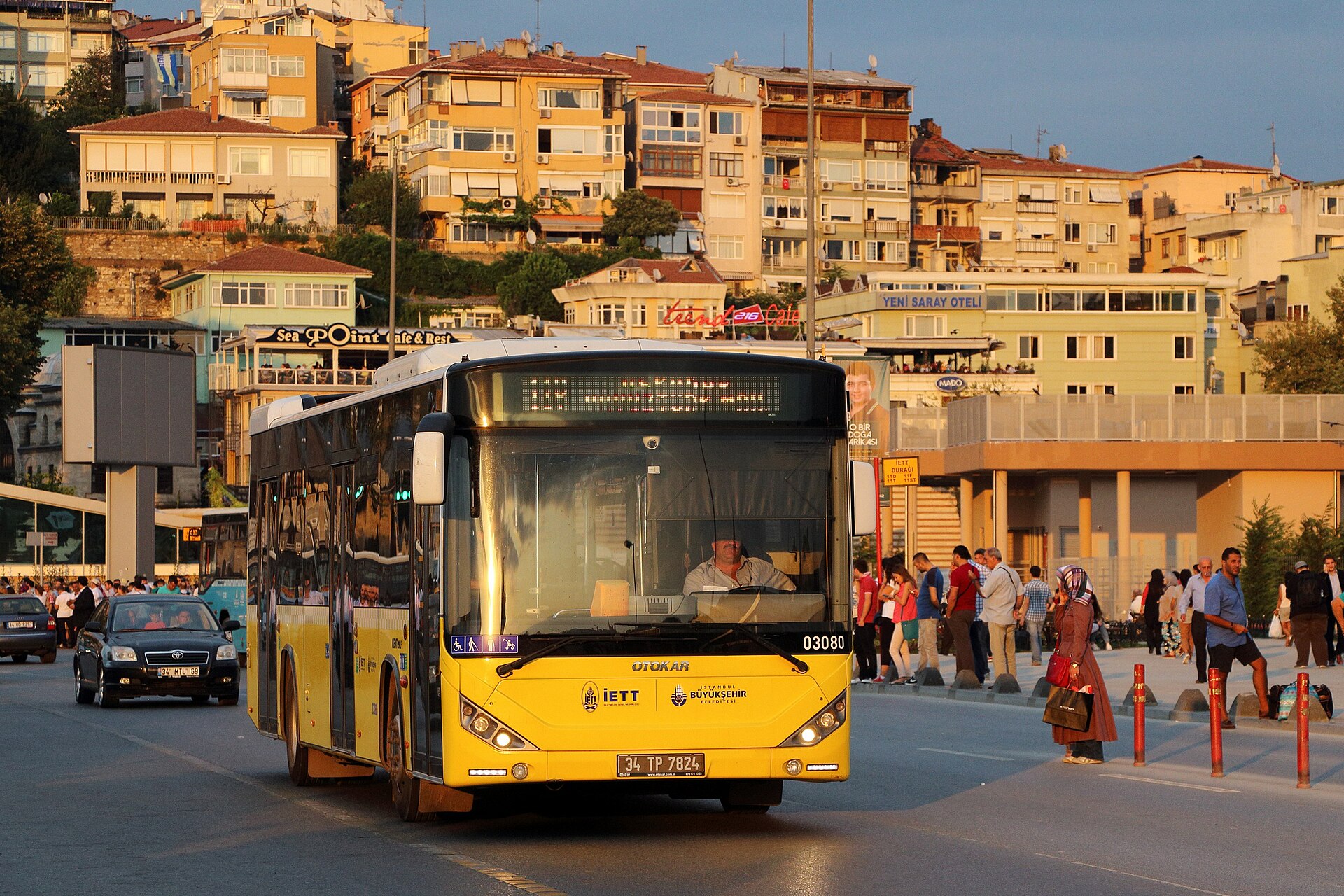A yellow Otokar Kent low-floor city bus in İETT livery on an Istanbul street.