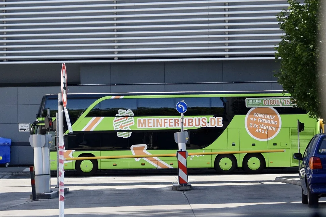 A modern double-deck FlixBus intercity coach at Munich central bus station, the kind of long-distance coach these driving games are built around.