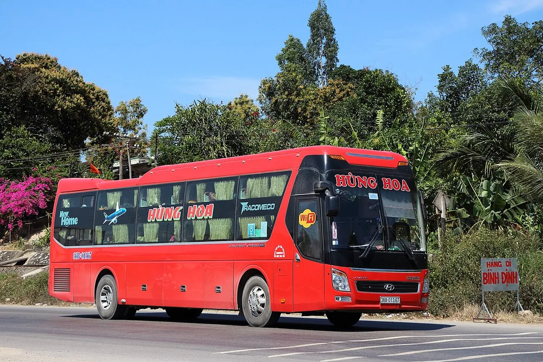 A Vietnamese Tracomeco sleeper coach on the road in Vietnam.