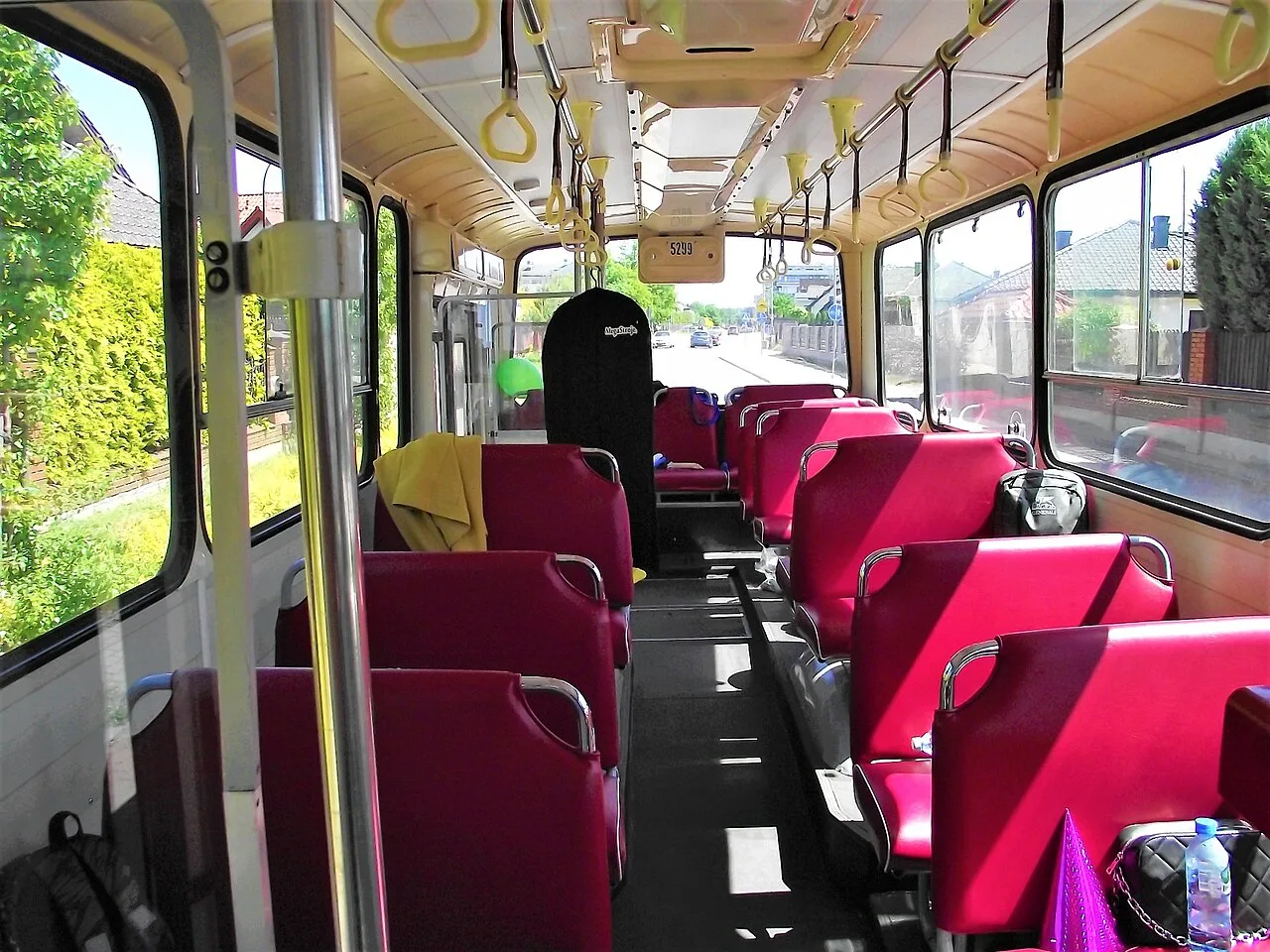 The driver's cab and interior of a Jelcz PR110 bus, with its simple analogue dashboard.