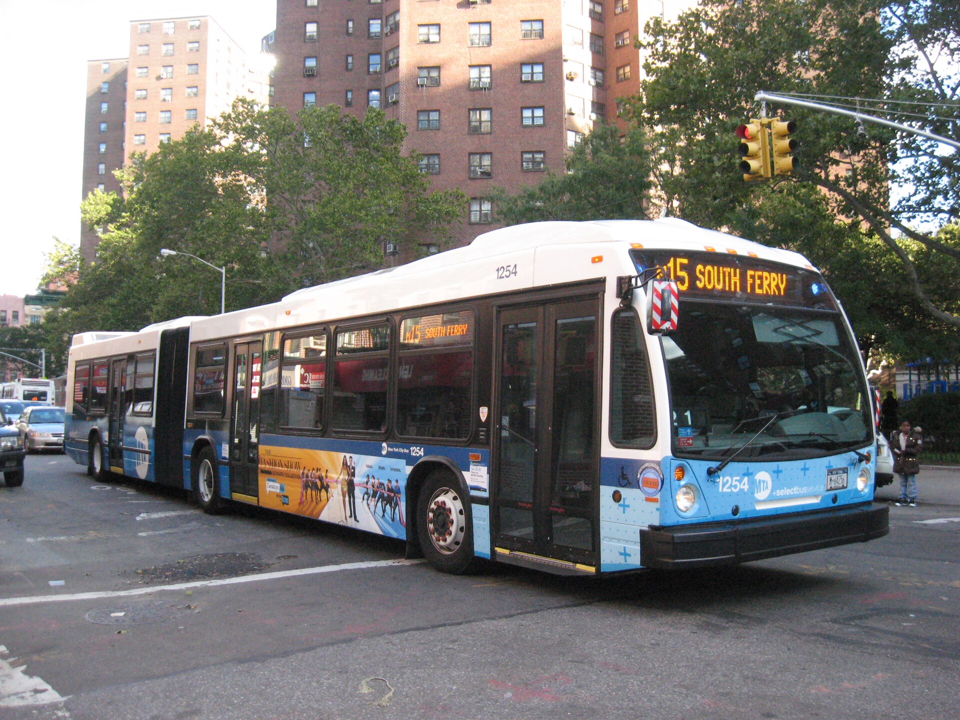 An articulated city bus pulling up to a stop — one of countless real-world models that bus-sim modders recreate.