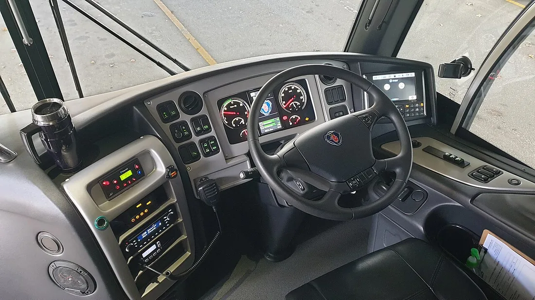 The dashboard and instrument cluster of a Scania coach, the driver's view of an air-braked bus.