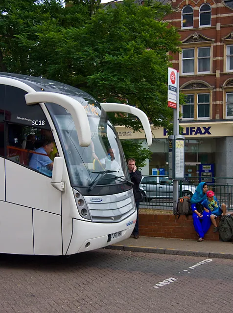 National Express coaches picking up passengers at a coach stop at Golders Green, London.