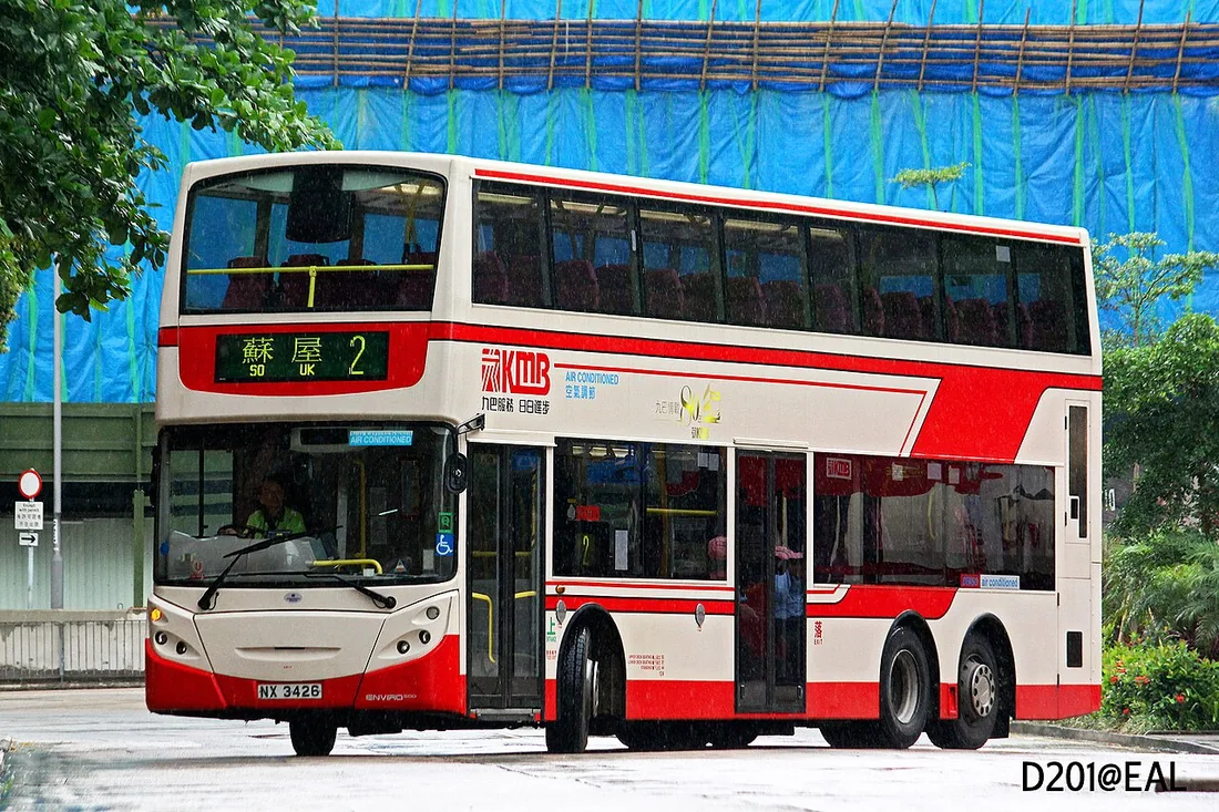 A three-axle Alexander Dennis Enviro500 double-decker bus, showing the extra rear tag axle behind the driven axle.